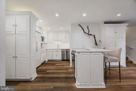 a view of kitchen with furniture and wooden floor