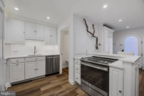 a kitchen with sink stove and cabinets
