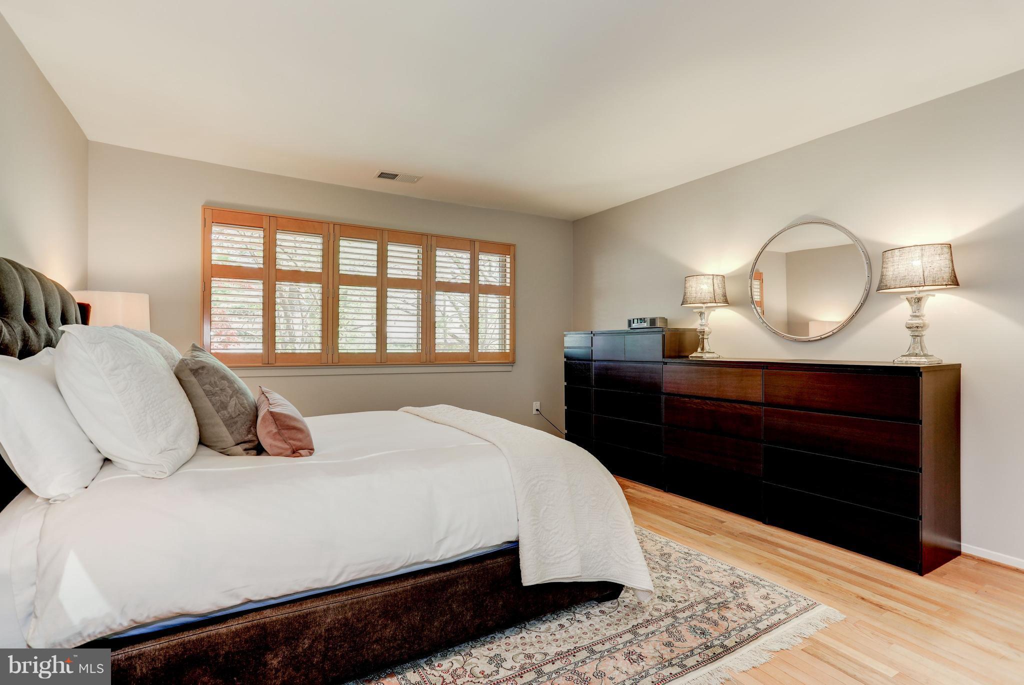 11762 Indian Ridge Road Reston, VA 20191 - Photo 14 of 30 a bedroom with a bed a mirror and a window