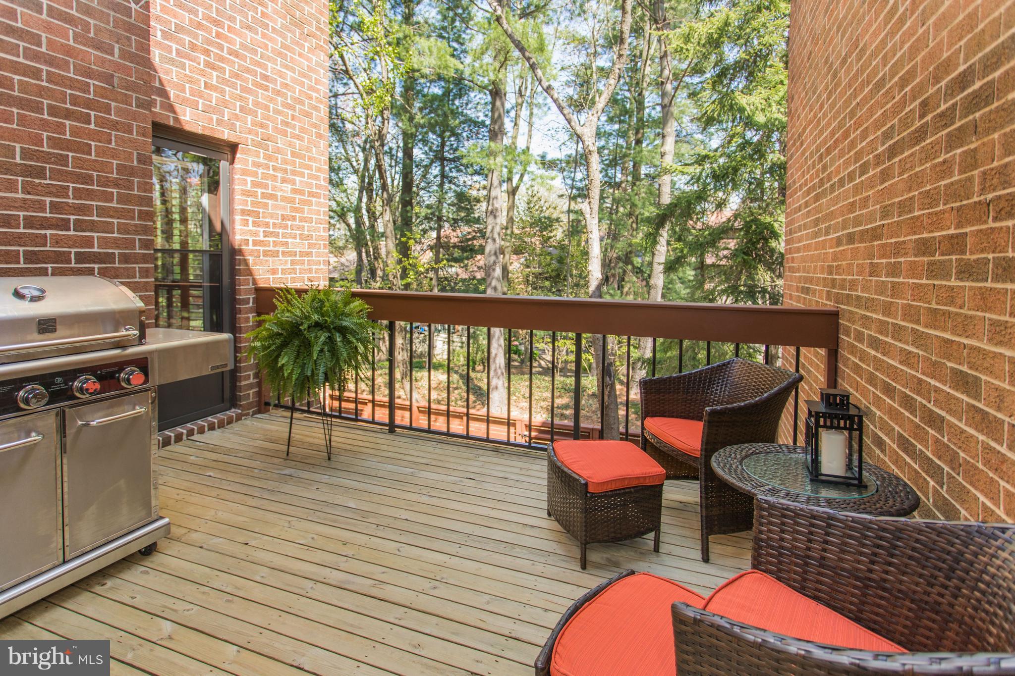 11762 Indian Ridge Road Reston, VA 20191 - Photo 23 of 30 a balcony with wooden floor table and chairs