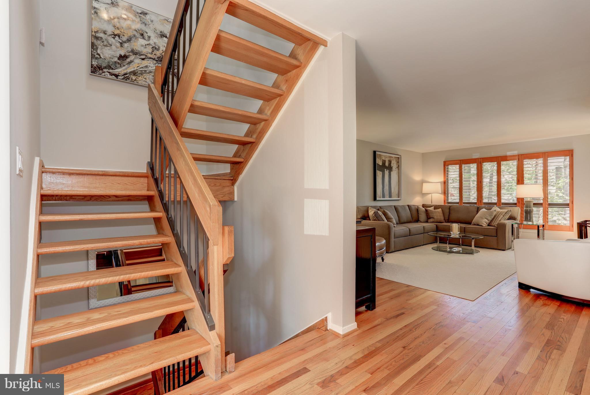 11762 Indian Ridge Road Reston, VA 20191 - Photo 4 of 30 a view of a livingroom with wooden floor and stairs