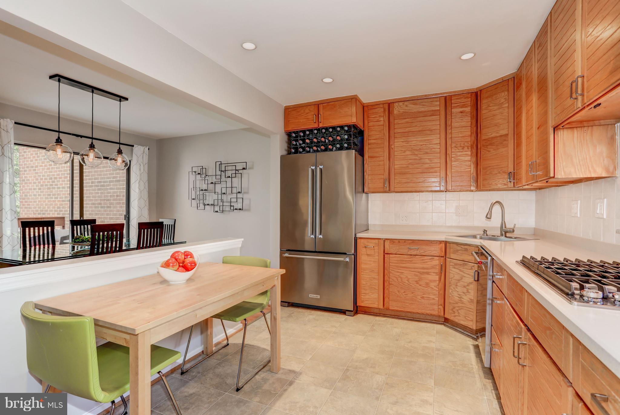 11762 Indian Ridge Road Reston, VA 20191 - Photo 8 of 30 a kitchen with stainless steel appliances granite countertop a sink refrigerator and cabinets