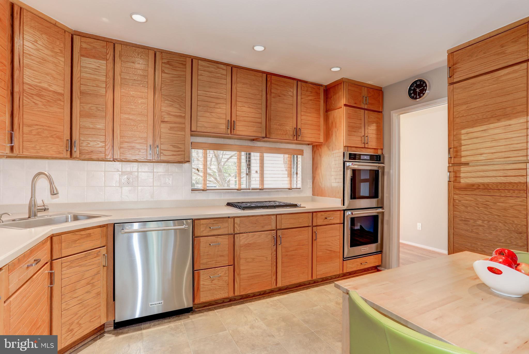 11762 Indian Ridge Road Reston, VA 20191 - Photo 9 of 30 a kitchen with granite countertop a sink and white cabinets