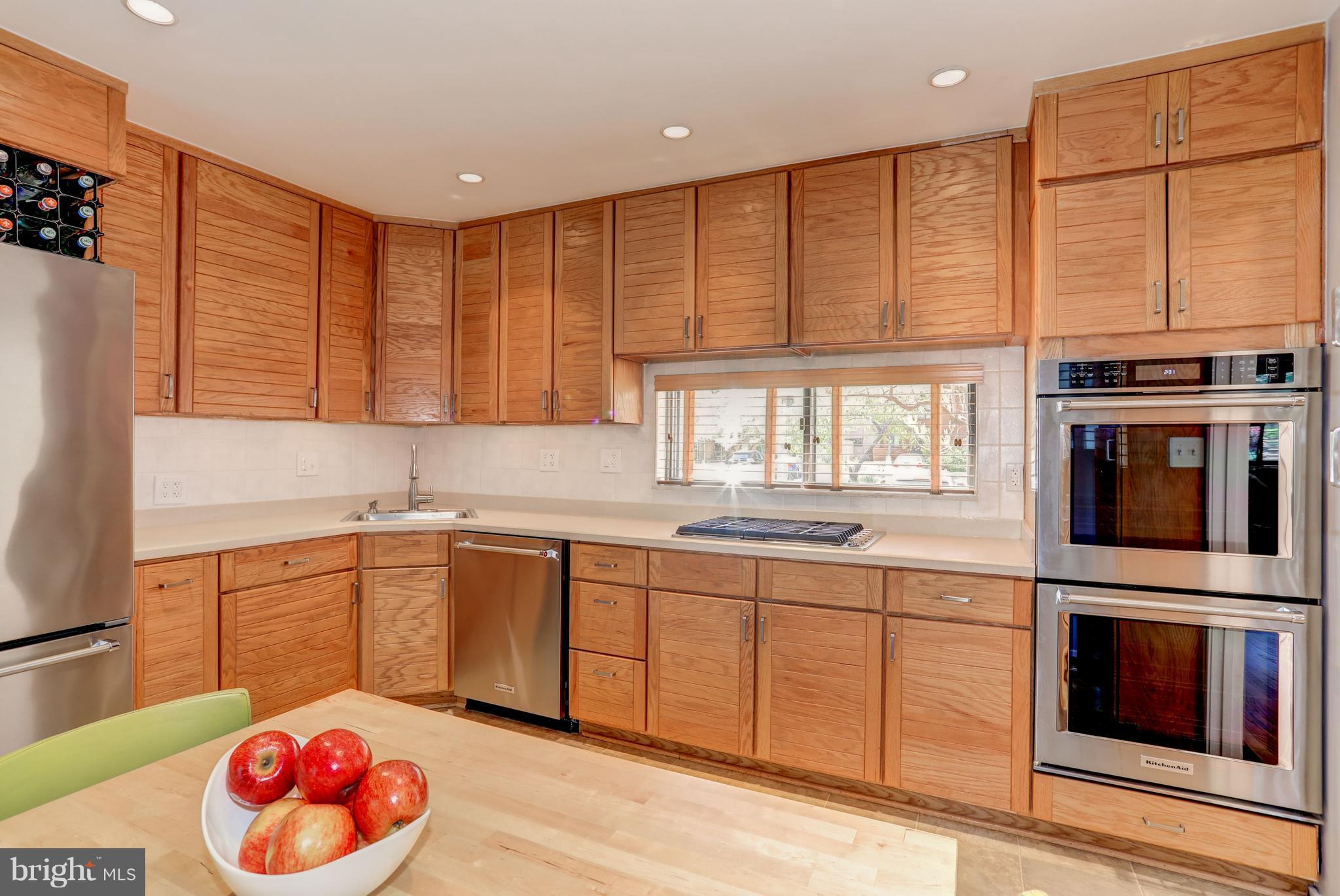 11762 Indian Ridge Road Reston, VA 20191 - Photo 10 of 30 a kitchen with stainless steel appliances granite countertop a stove a sink and a microwave