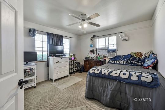 1260 Arroyo Street Ridgecrest, CA 93555 - Photo 19 of 44 a bedroom with furniture and flat screen tv