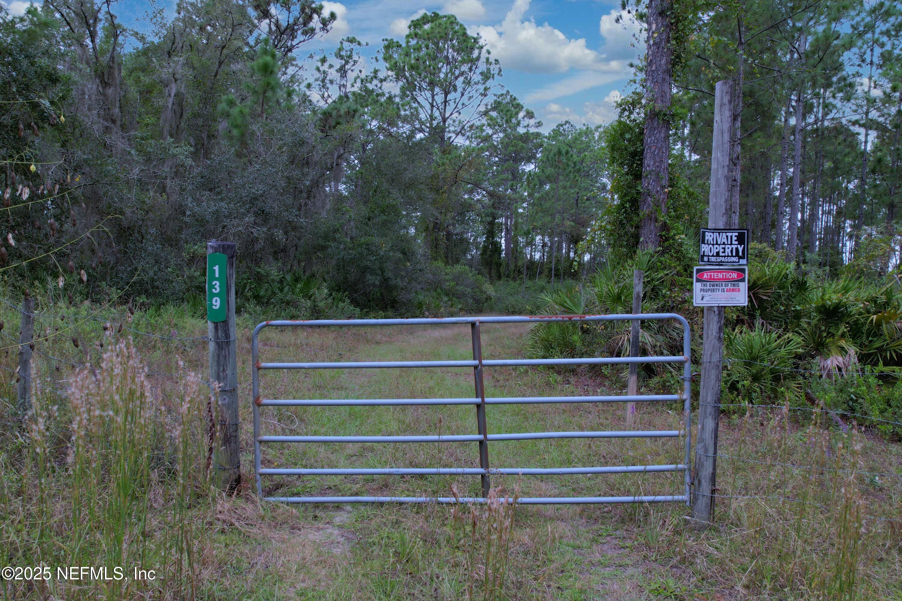 139 Lakeway Drive Georgetown, FL 32139 - Photo 12 of 59 a view of a wooden fence and trees