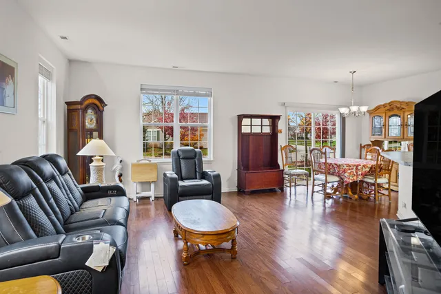 a living room with furniture dining table and a large window