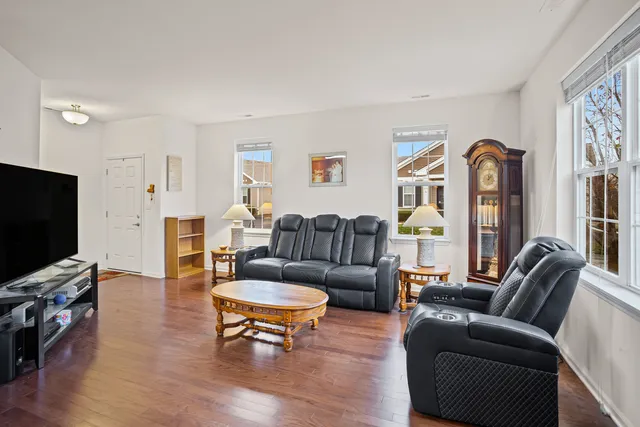 a living room with fireplace furniture and a flat screen tv