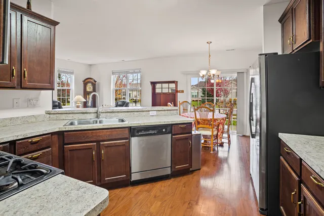 a kitchen with stainless steel appliances granite countertop a sink stove and refrigerator