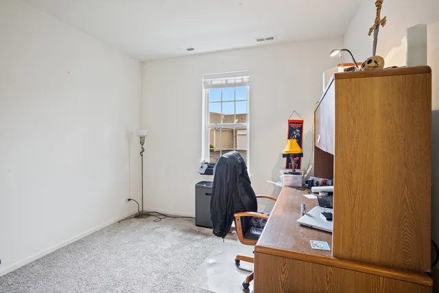 a view of a workspace with furniture and gym equipment