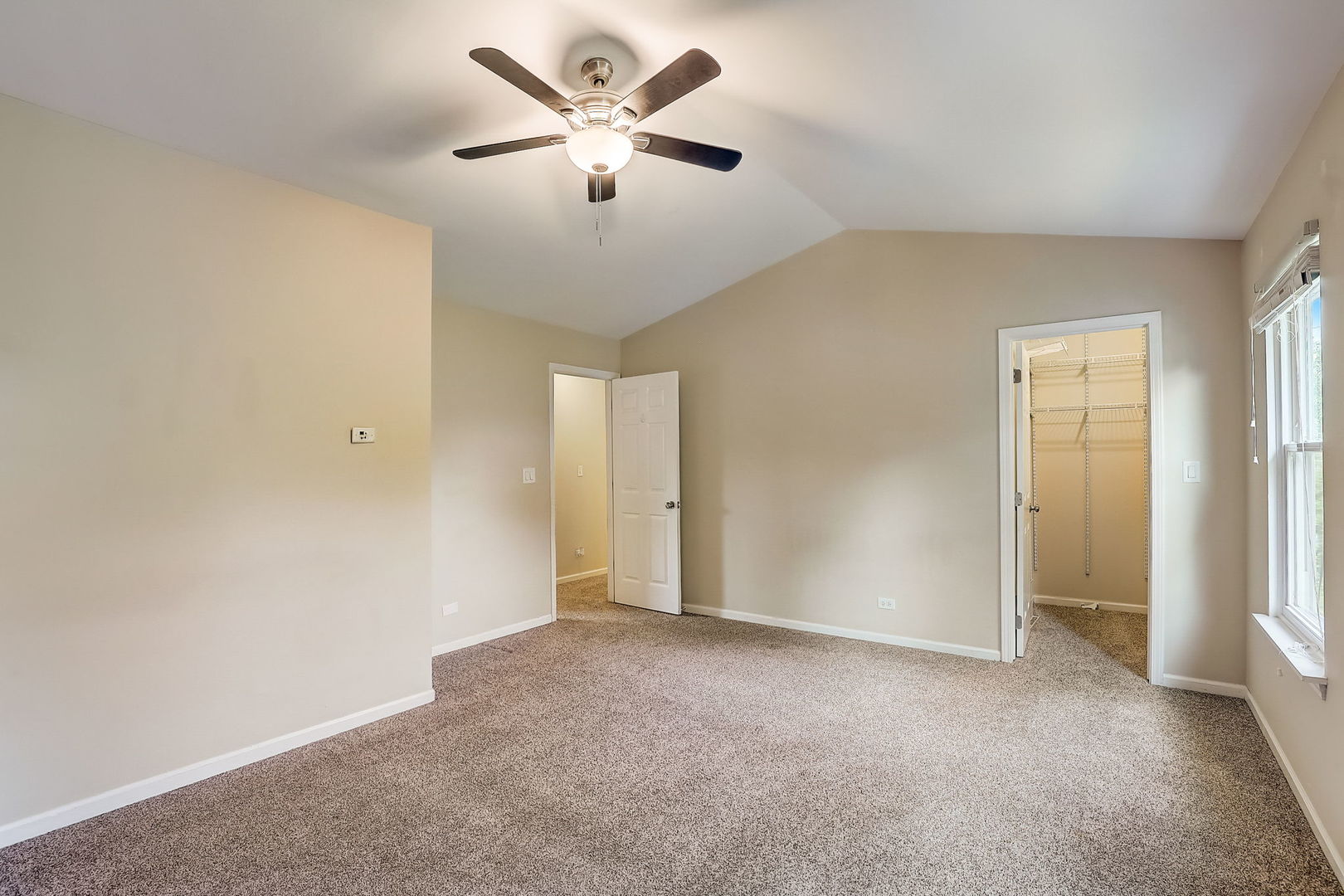 733 Thunderbird Trail Carol Stream, IL 60188 - Photo 16 of 31 an empty room with chandelier fan and windows