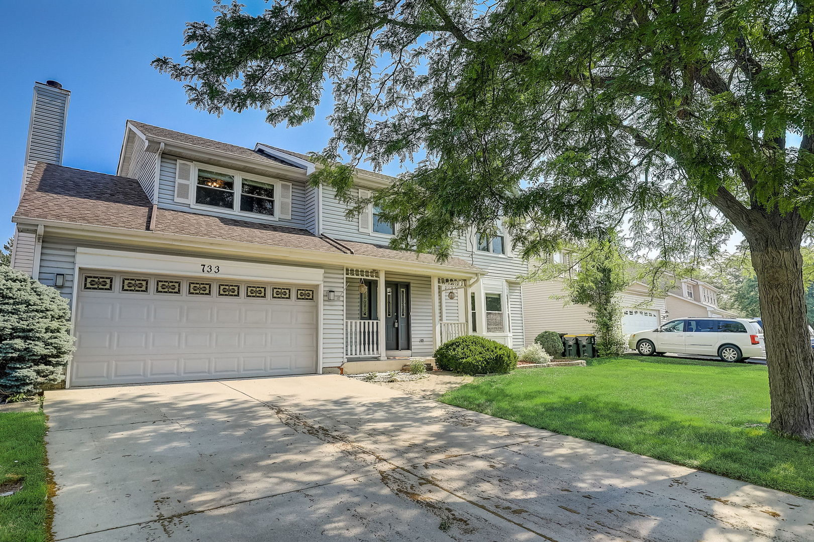 733 Thunderbird Trail Carol Stream, IL 60188 - Photo 28 of 31 a front view of a house with a yard and trees