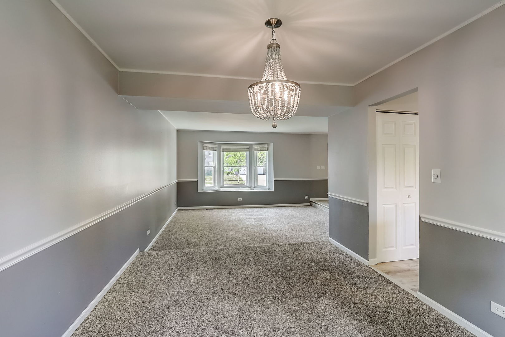 733 Thunderbird Trail Carol Stream, IL 60188 - Photo 4 of 31 wooden floor in an empty room with a window