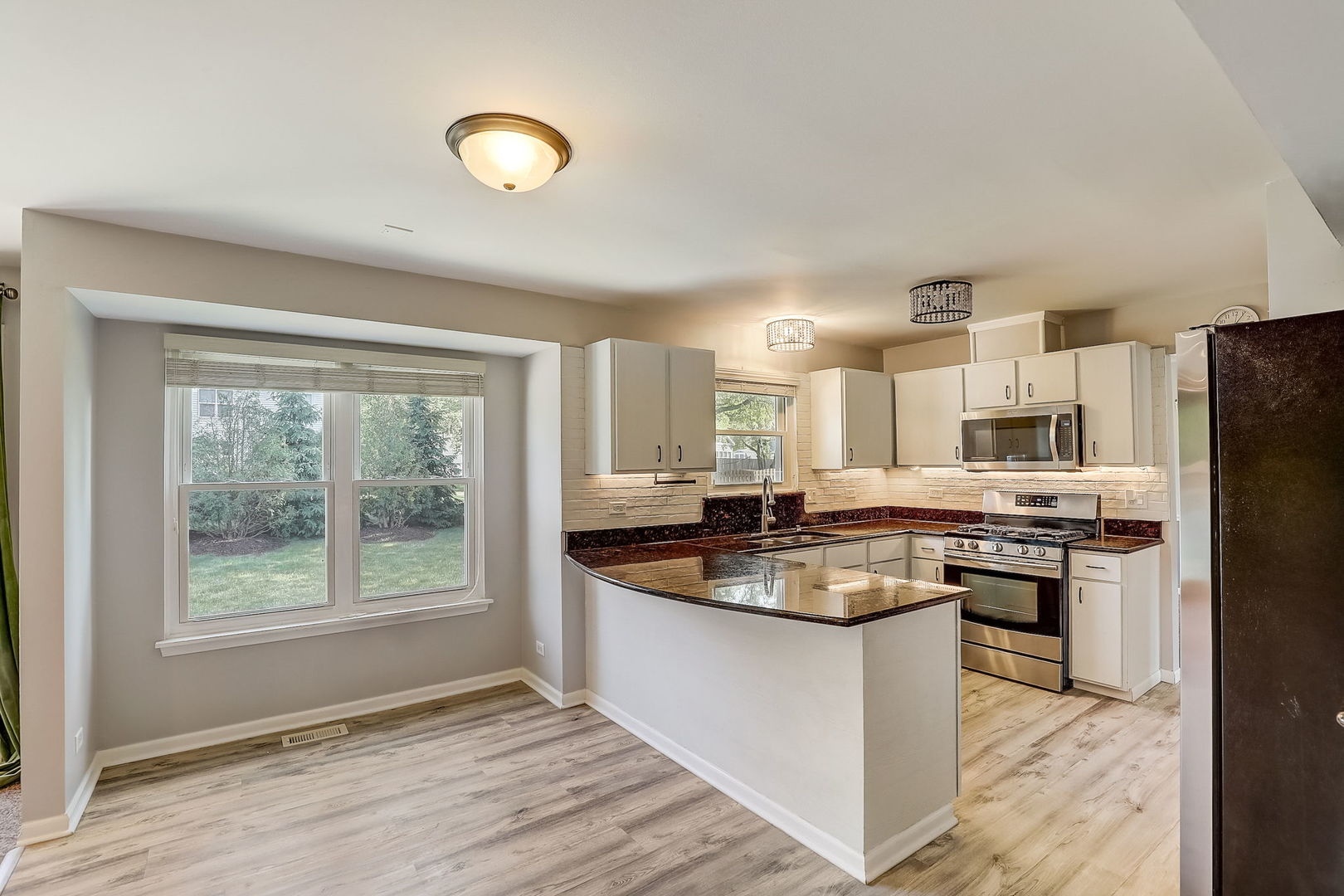 733 Thunderbird Trail Carol Stream, IL 60188 - Photo 5 of 31 a kitchen with stainless steel appliances granite countertop a sink stove and refrigerator