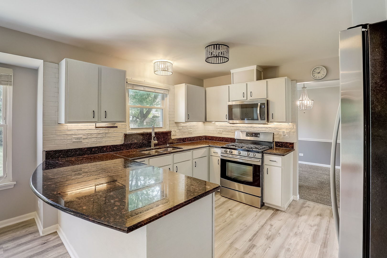733 Thunderbird Trail Carol Stream, IL 60188 - Photo 6 of 31 a kitchen with stainless steel appliances granite countertop a stove a sink and a refrigerator