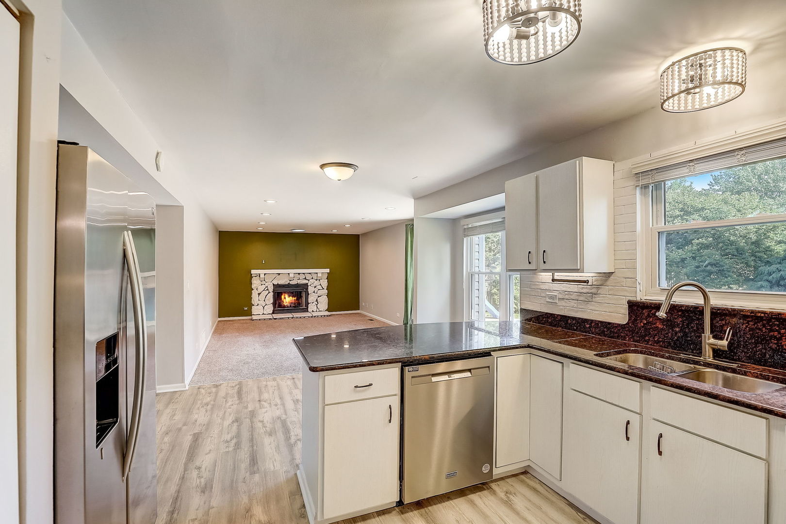 733 Thunderbird Trail Carol Stream, IL 60188 - Photo 8 of 31 a kitchen with granite countertop a sink cabinets stainless steel appliances and a window