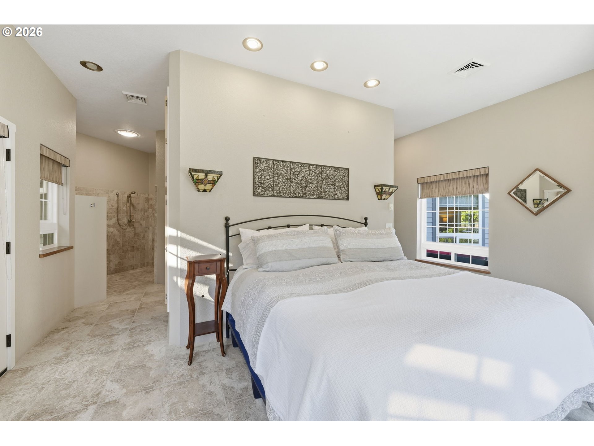 5200 Dunewood Drive Florence, OR 97439 - Photo 19 of 48 a spacious bedroom with a bed and a large mirror