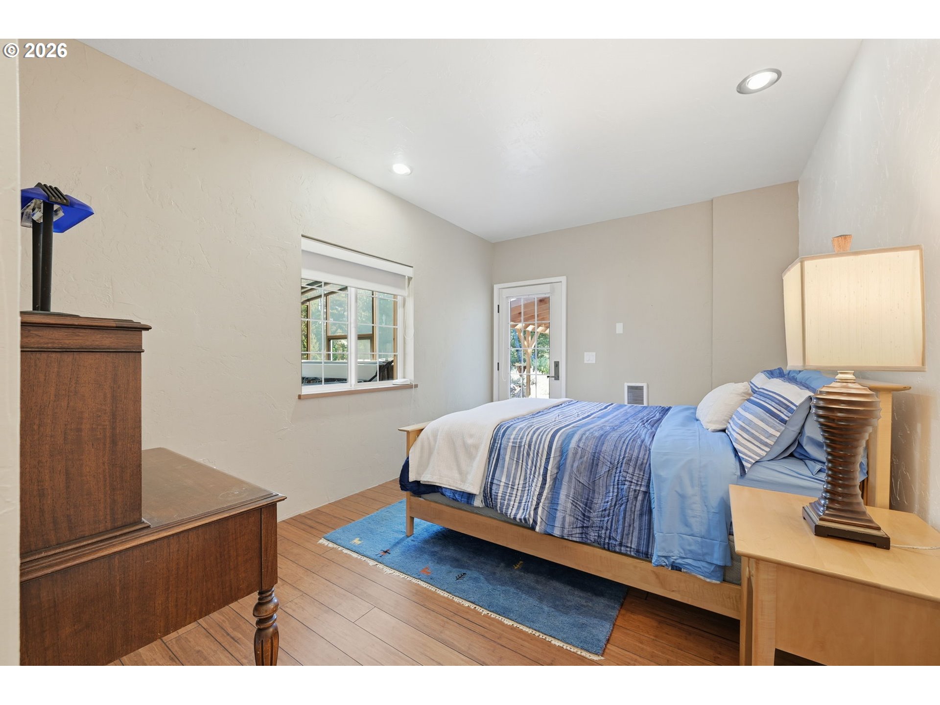 5200 Dunewood Drive Florence, OR 97439 - Photo 27 of 48 a bedroom with a bed and a night stand