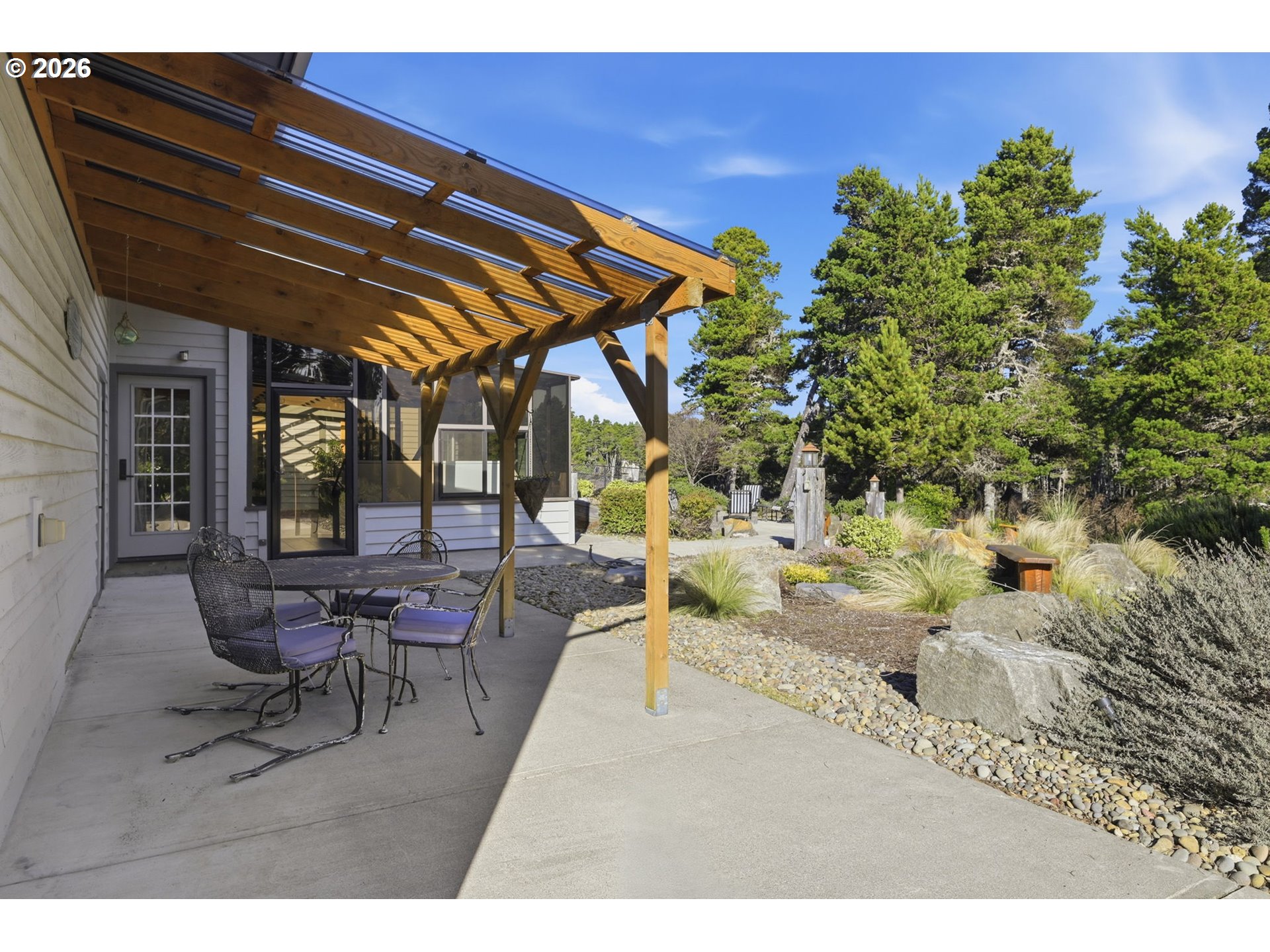 5200 Dunewood Drive Florence, OR 97439 - Photo 33 of 48 a backyard of a house with table and chairs