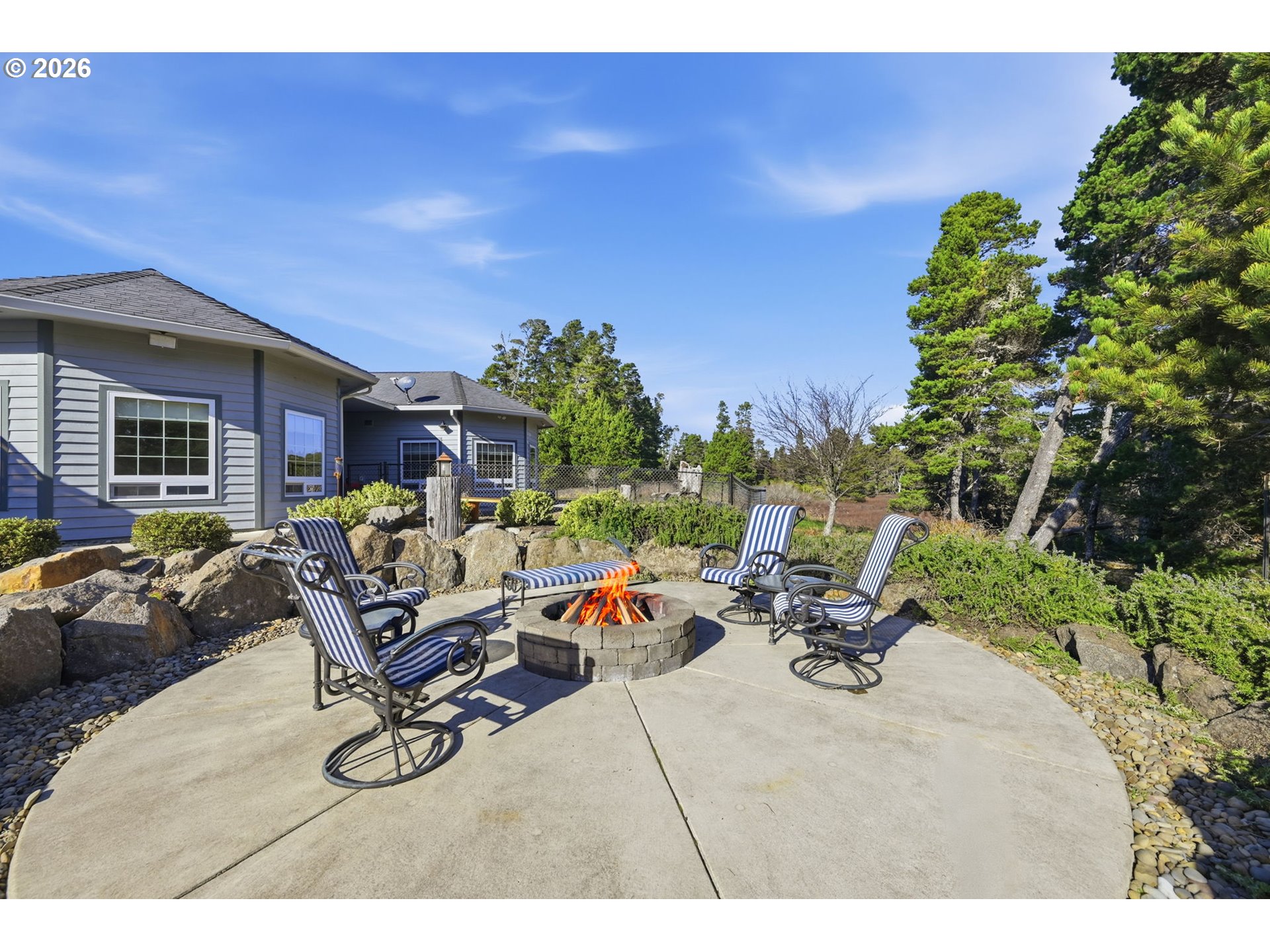 5200 Dunewood Drive Florence, OR 97439 - Photo 35 of 48 a view of a patio with couches and a table and chairs with wooden fence