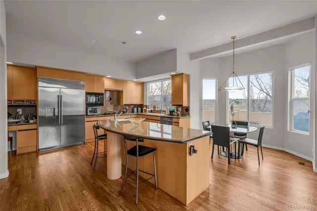 a kitchen with stainless steel appliances granite countertop wooden floors and stove