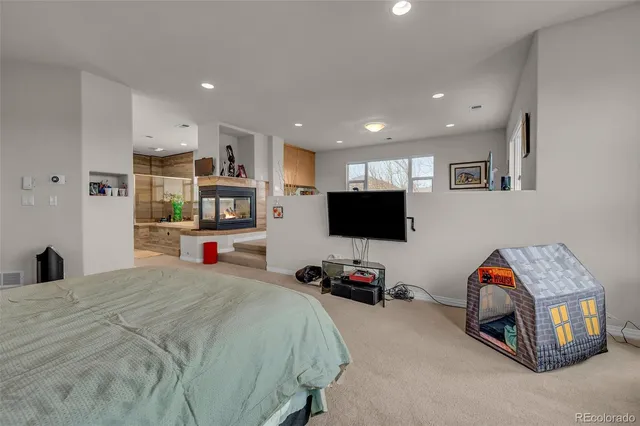 a bed room with furniture and a flat screen tv