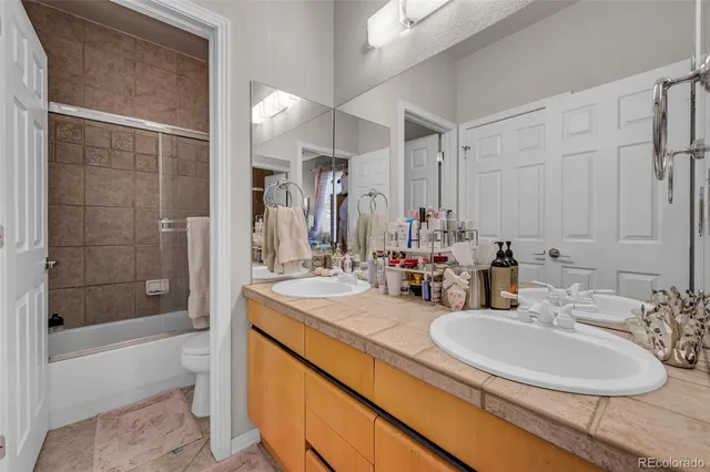 a bedroom with a bed a dresser and a book shelf