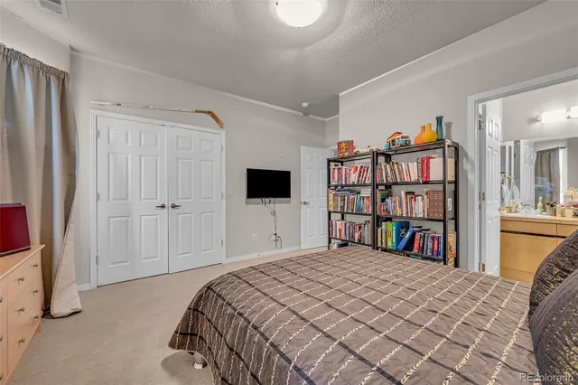 a bedroom with a bed furniture and a book shelf