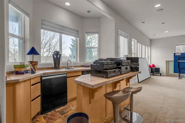 a spacious bathroom with a granite countertop sink mirror and shower