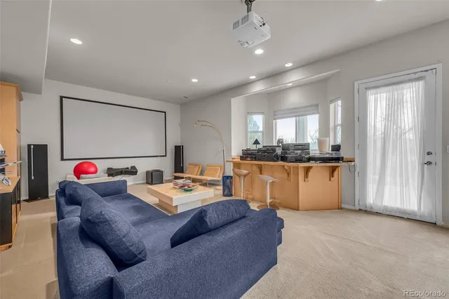 a living room with furniture a window and kitchen view