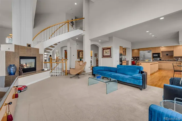 a living room with furniture and a floor to ceiling window