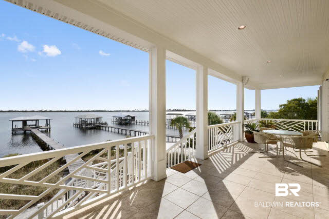 33168 River Road Orange Beach, AL 36561 - Photo 2 of 11 Large 9.3' X 53' covered balcony facing south and overlooking Old River, the Florida State Preserve and the Gulf of Mexico-