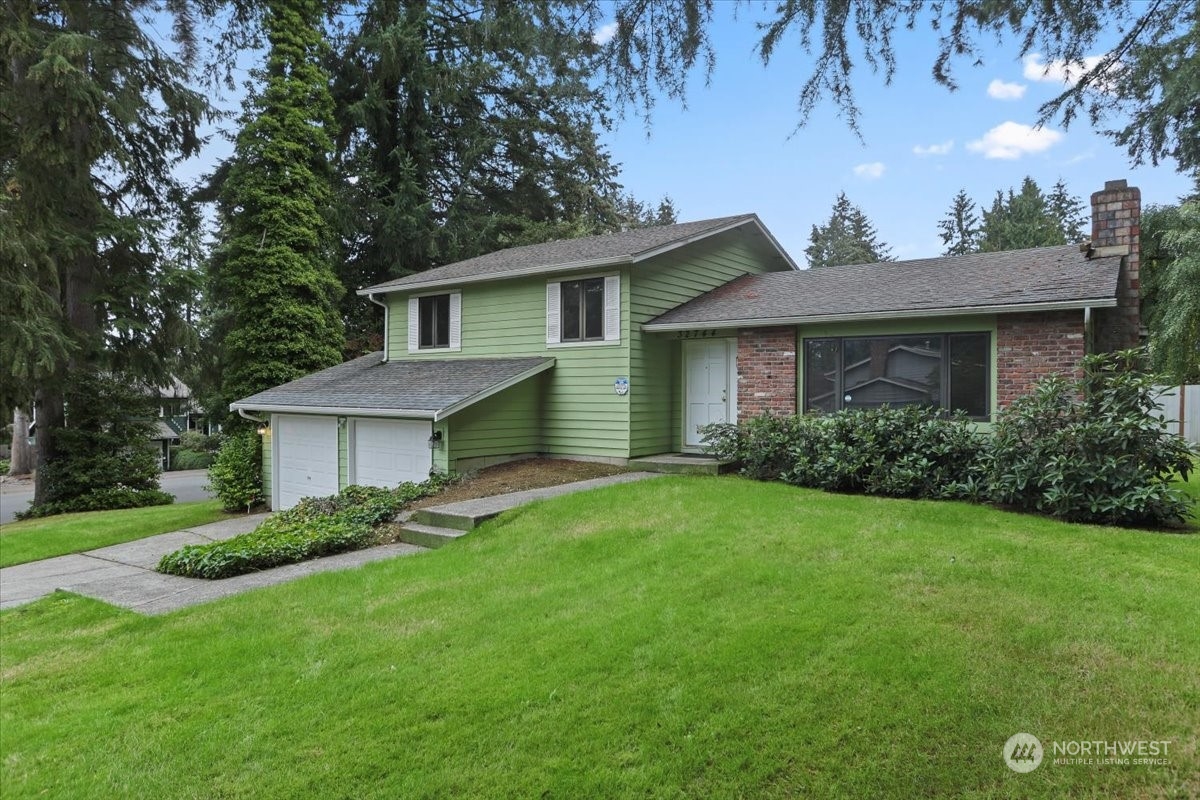 32744 30th Avenue Southwest Federal Way, WA 98023 - Photo 1 of 28 a front view of a house with a garden