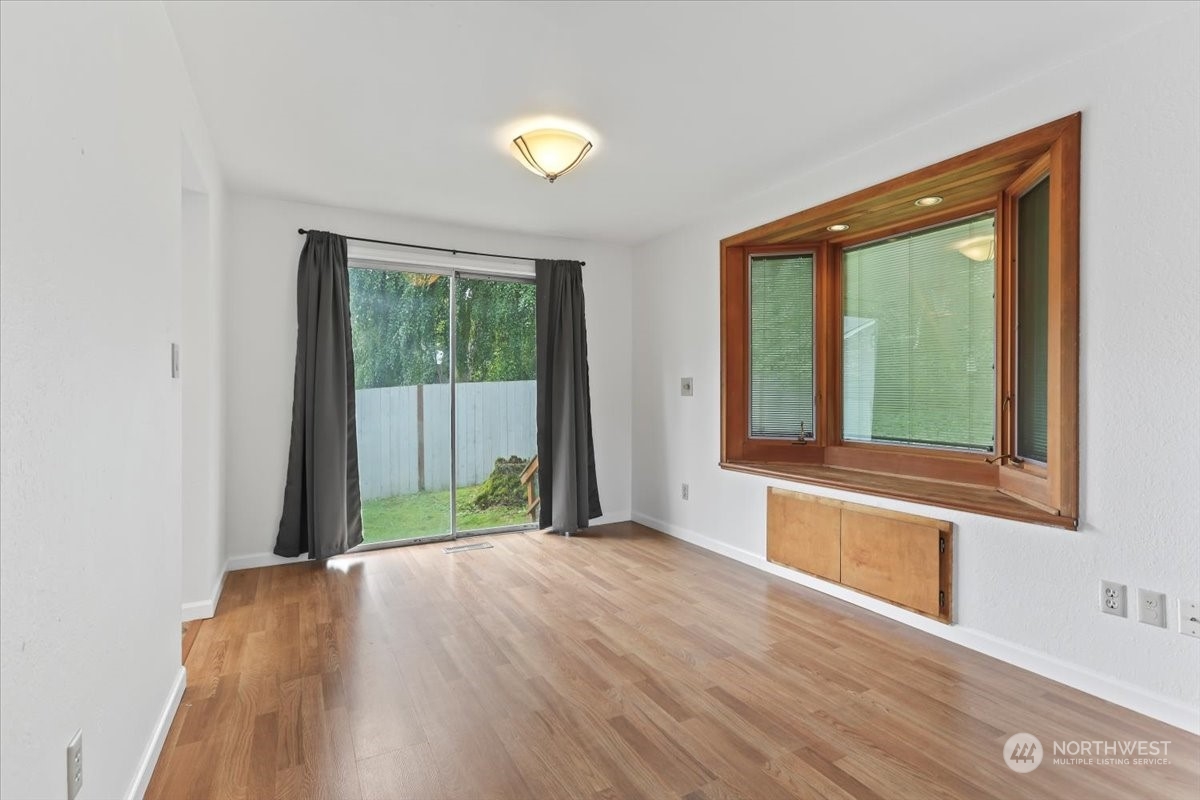 32744 30th Avenue Southwest Federal Way, WA 98023 - Photo 11 of 28 a view of a bedroom with wooden floor and windows