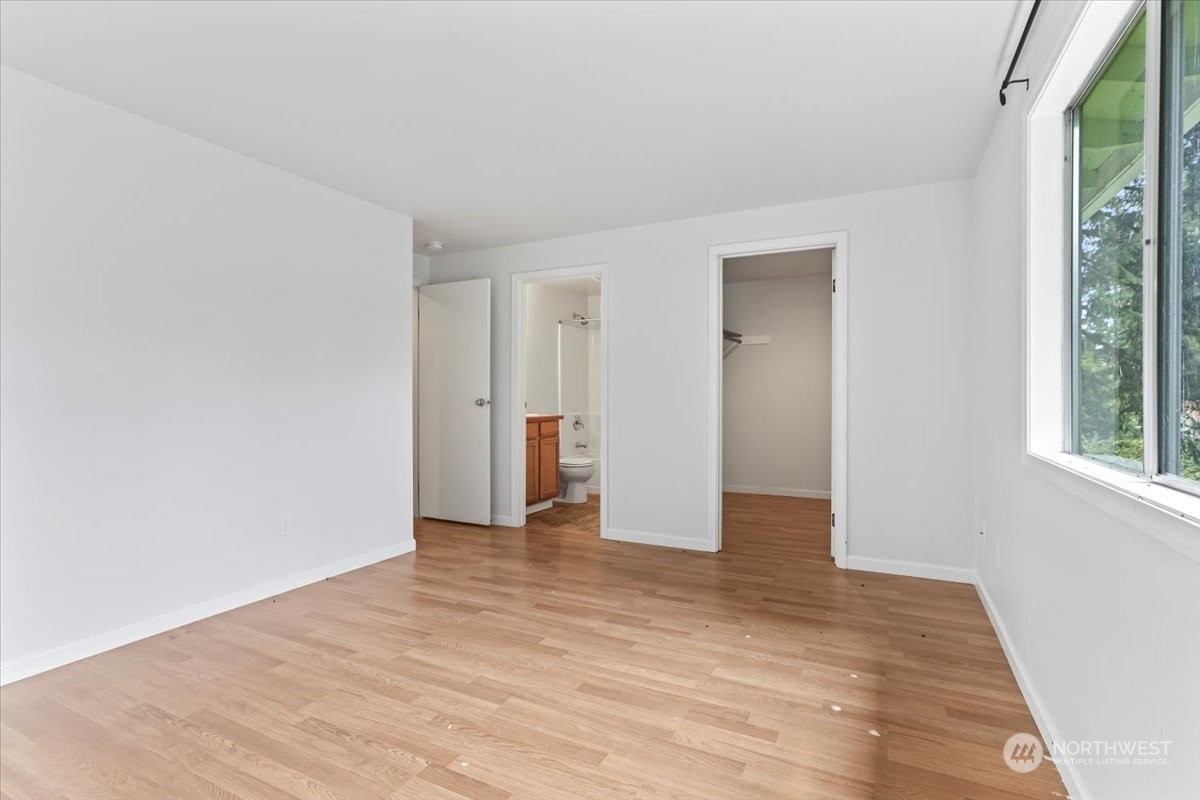 32744 30th Avenue Southwest Federal Way, WA 98023 - Photo 15 of 28 a view of an empty room with wooden floor and a window