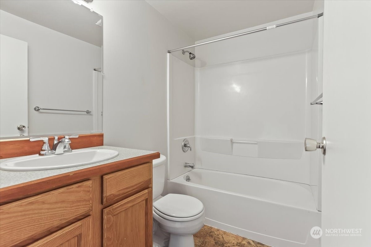 32744 30th Avenue Southwest Federal Way, WA 98023 - Photo 16 of 28 a bathroom with a sink a toilet and a mirror