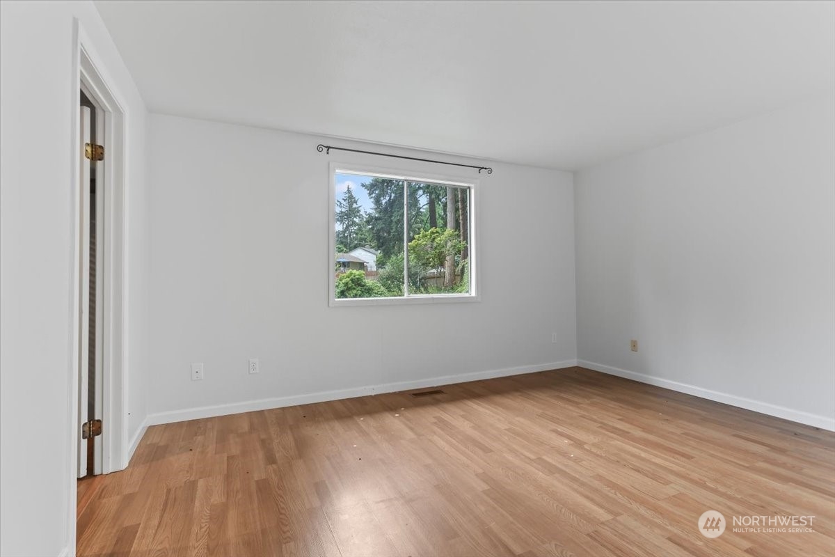 32744 30th Avenue Southwest Federal Way, WA 98023 - Photo 18 of 28 an empty room with wooden floor and windows