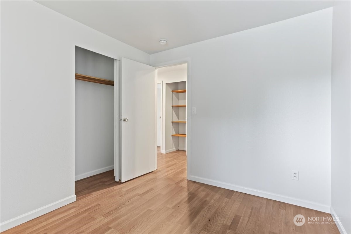 32744 30th Avenue Southwest Federal Way, WA 98023 - Photo 19 of 28 a view of an empty room with wooden floor and closet