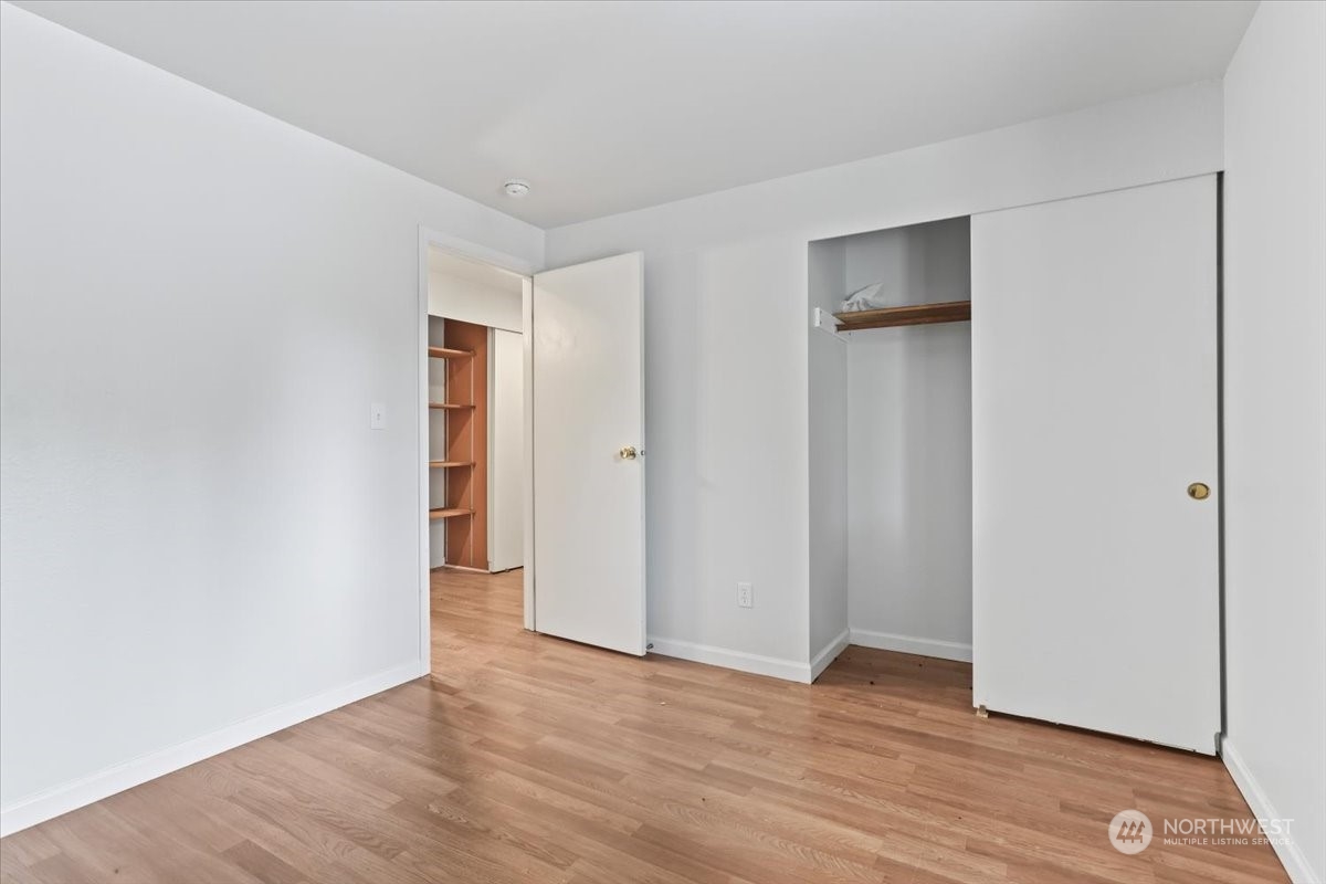 32744 30th Avenue Southwest Federal Way, WA 98023 - Photo 20 of 28 a view of an empty room with wooden floor and closet