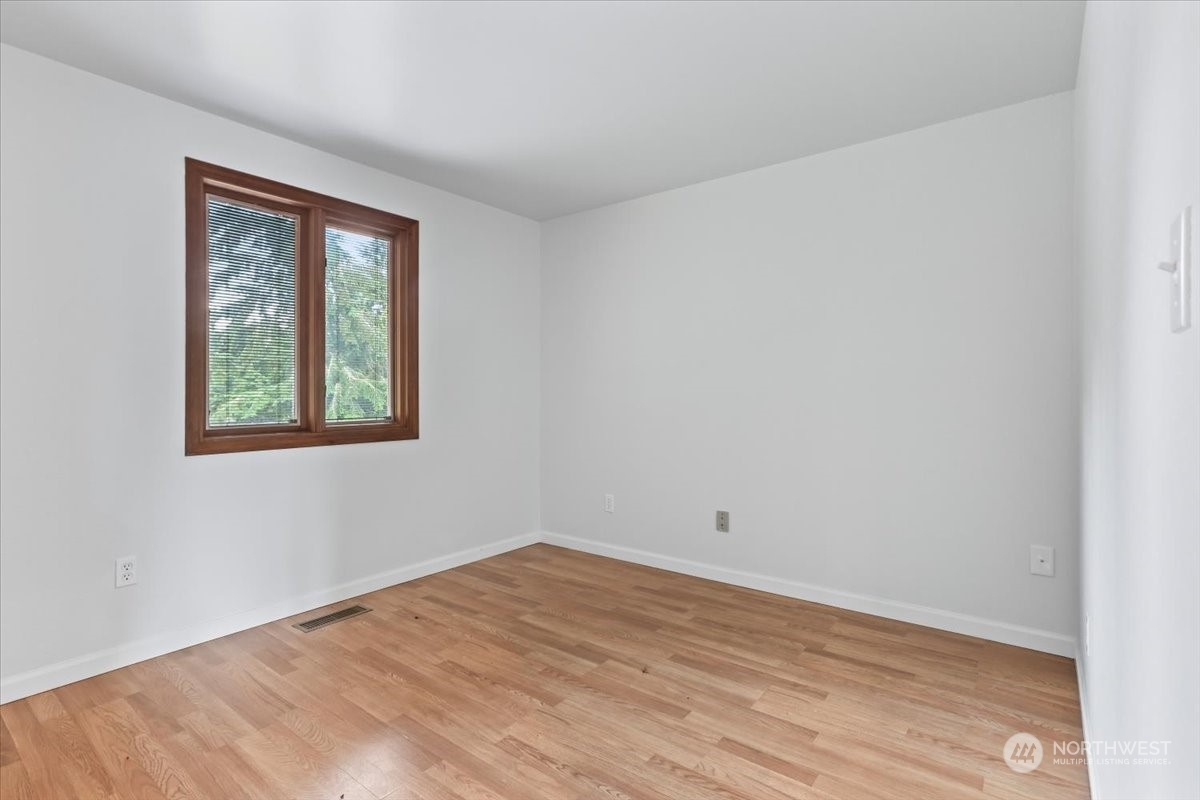 32744 30th Avenue Southwest Federal Way, WA 98023 - Photo 21 of 28 wooden floor in an empty room with a window