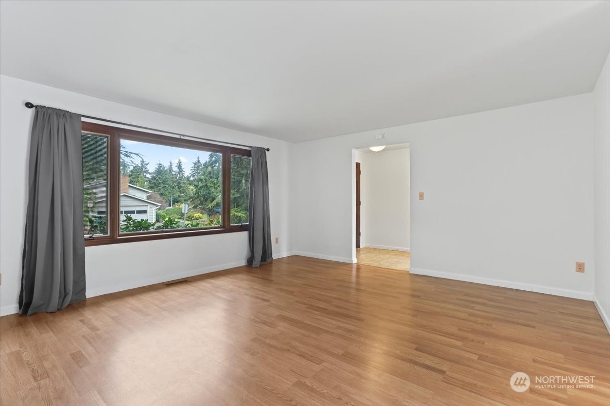 32744 30th Avenue Southwest Federal Way, WA 98023 - Photo 9 of 28 a view of an empty room with wooden floor and a window