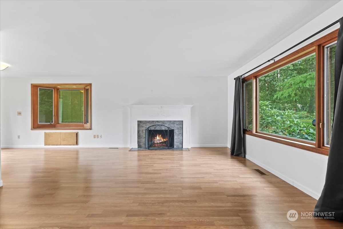 32744 30th Avenue Southwest Federal Way, WA 98023 - Photo 10 of 28 a view of an empty room with wooden floor and a window