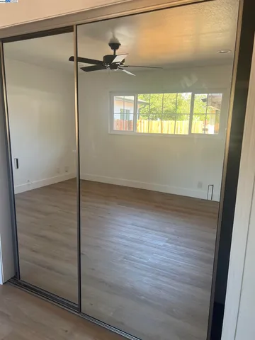 a view of a room with wooden floor and a window