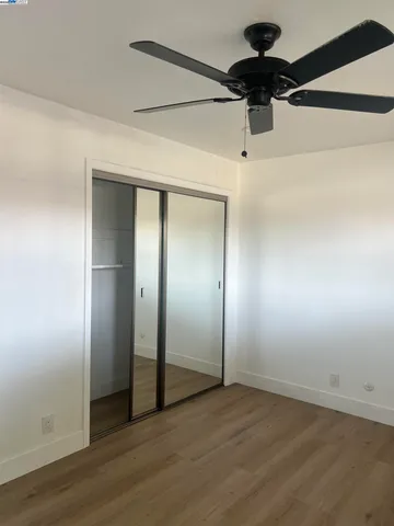 an empty room with windows and closet
