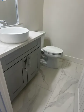 a bathroom with a sink a toilet and vanity