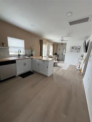 a large white kitchen with granite countertop lots of counter top space