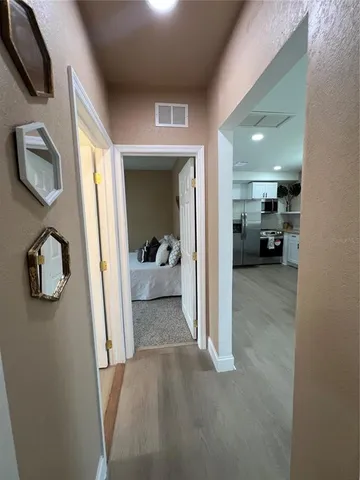 a view of a livingroom with furniture and a entryway