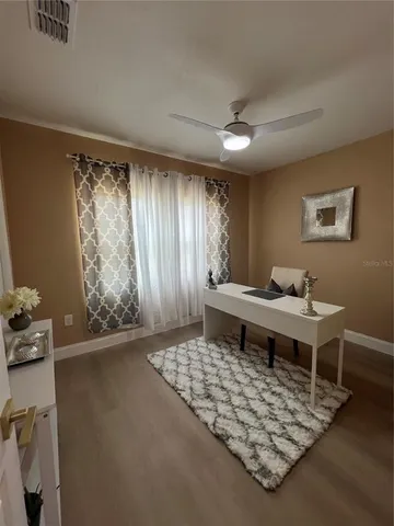 a living room with a rug and a table