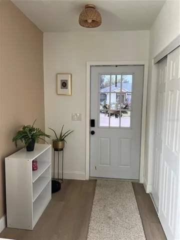 a view of an entryway with wooden floor