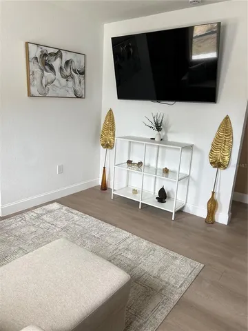 a view of a room with wooden floor